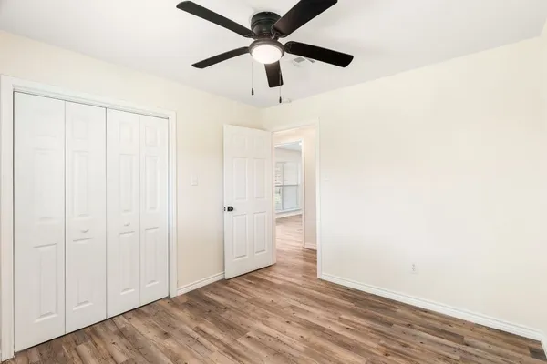 a view of an empty room and wooden floor