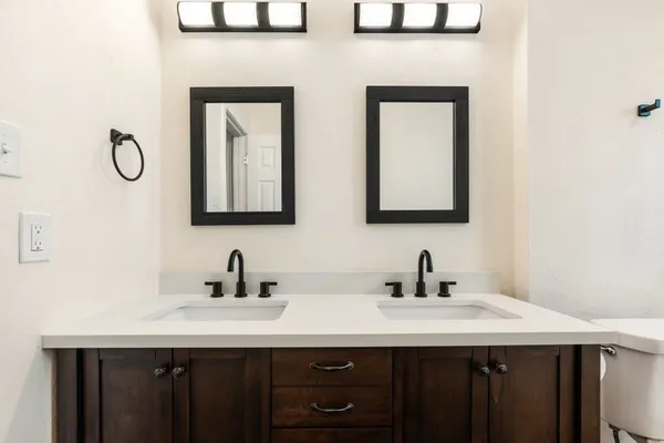 a bathroom with a double vanity sink and a mirror