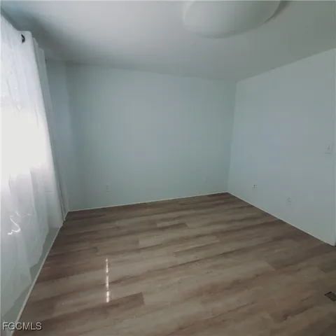 a view of a room with wooden floor