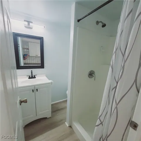 a bathroom with a sink a mirror and shower