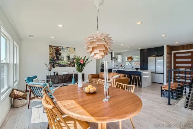 a dining room with furniture and wooden floor