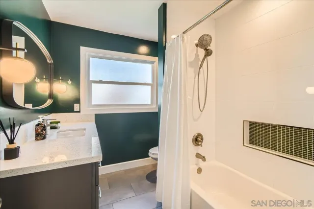 a bathroom with a sink vanity and a mirror