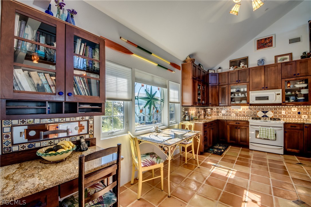 2702 Bruce Street Matlacha, FL 33993 - Photo 15 of 50 a kitchen with stainless steel appliances granite countertop a stove and a refrigerator