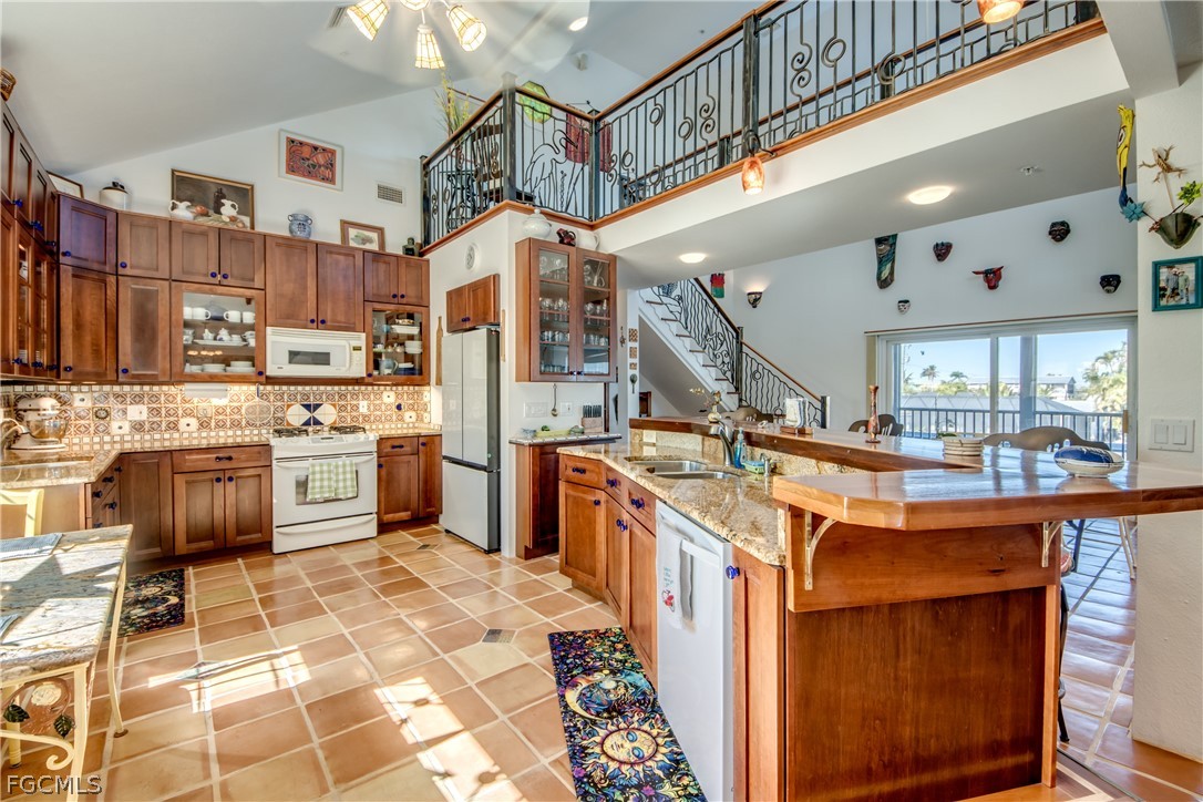 2702 Bruce Street Matlacha, FL 33993 - Photo 19 of 50 a kitchen with stainless steel appliances granite countertop a sink and a stove