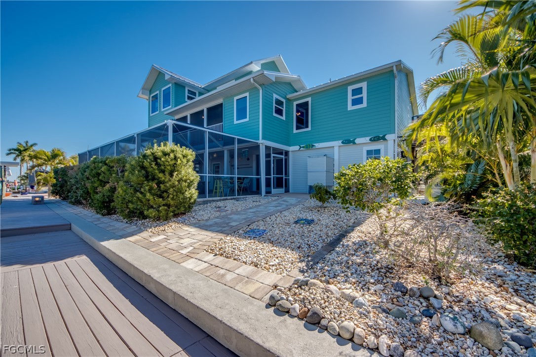 2702 Bruce Street Matlacha, FL 33993 - Photo 2 of 50 a front view of a house with garden