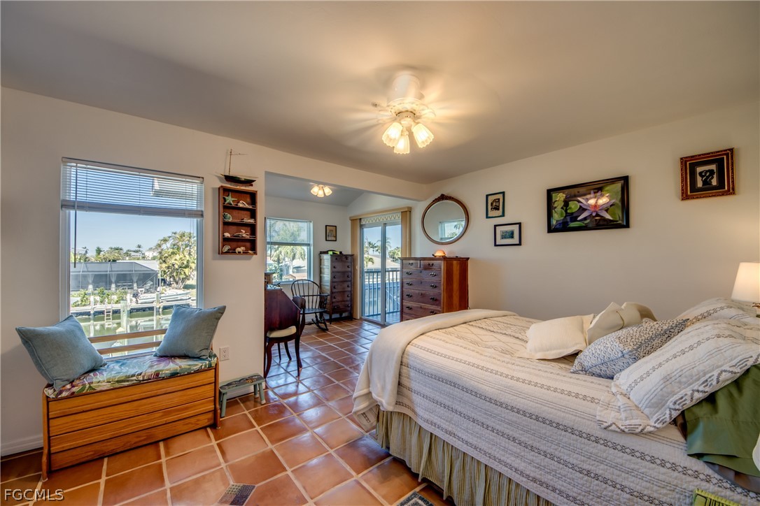 2702 Bruce Street Matlacha, FL 33993 - Photo 22 of 50 a bedroom with a bed and wooden floor