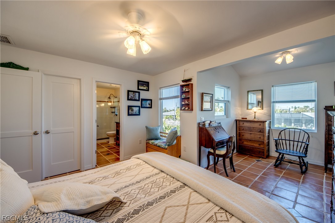 2702 Bruce Street Matlacha, FL 33993 - Photo 23 of 50 a bedroom with a bed and a chandelier