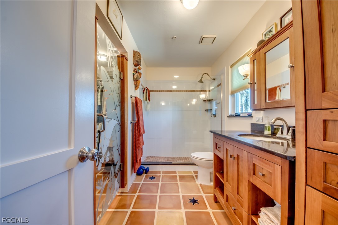 2702 Bruce Street Matlacha, FL 33993 - Photo 24 of 50 a bathroom with a tub a sink and a shower