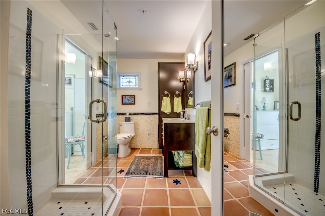 2702 Bruce Street Matlacha, FL 33993 - Photo 26 of 50 a room with lots of white furniture and glass door