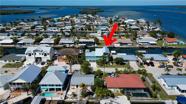 an aerial view of a houses with yard
