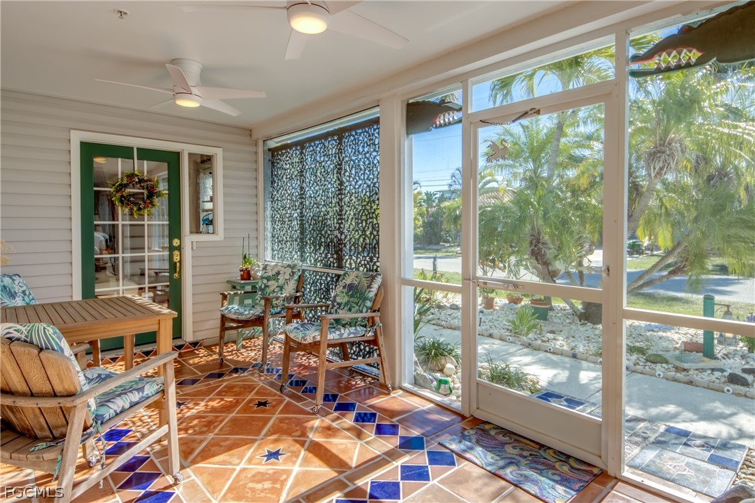2702 Bruce Street Matlacha, FL 33993 - Photo 9 of 50 a living room filled with furniture and floor to ceiling windows