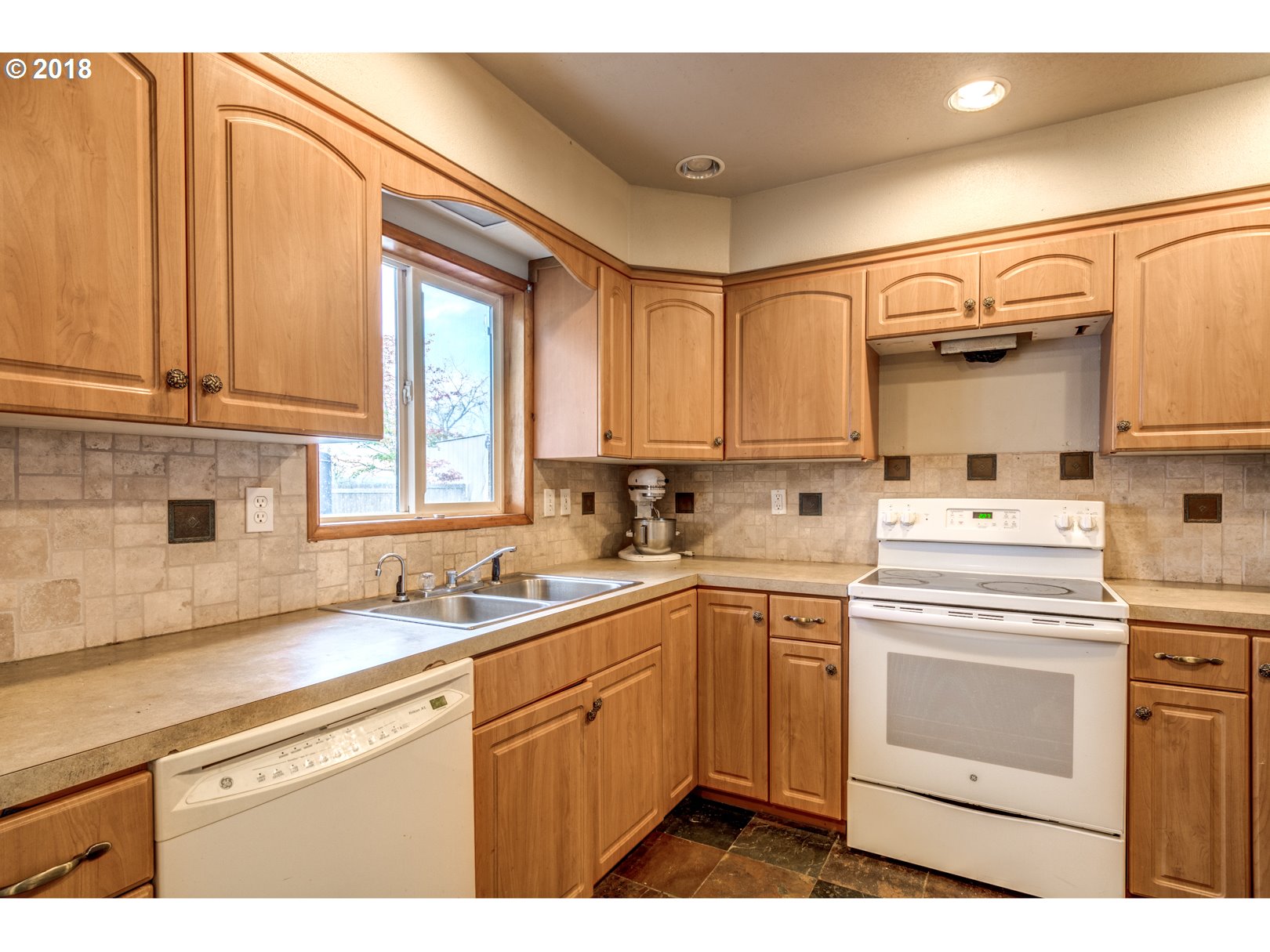 5744 Keene Road Northeast Gervais, OR 97026 - Photo 13 of 32 a kitchen with a sink a stove cabinets and a wooden floor