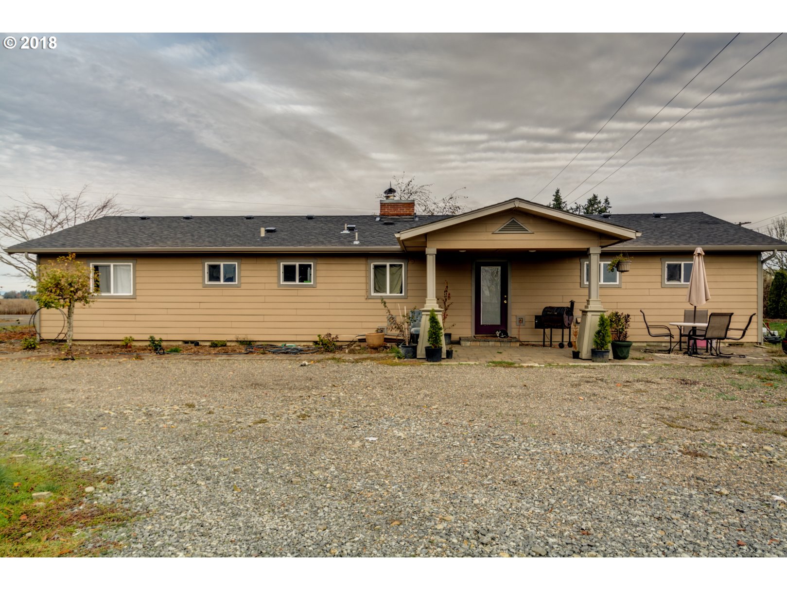 5744 Keene Road Northeast Gervais, OR 97026 - Photo 3 of 32 a front view of a house with a garden