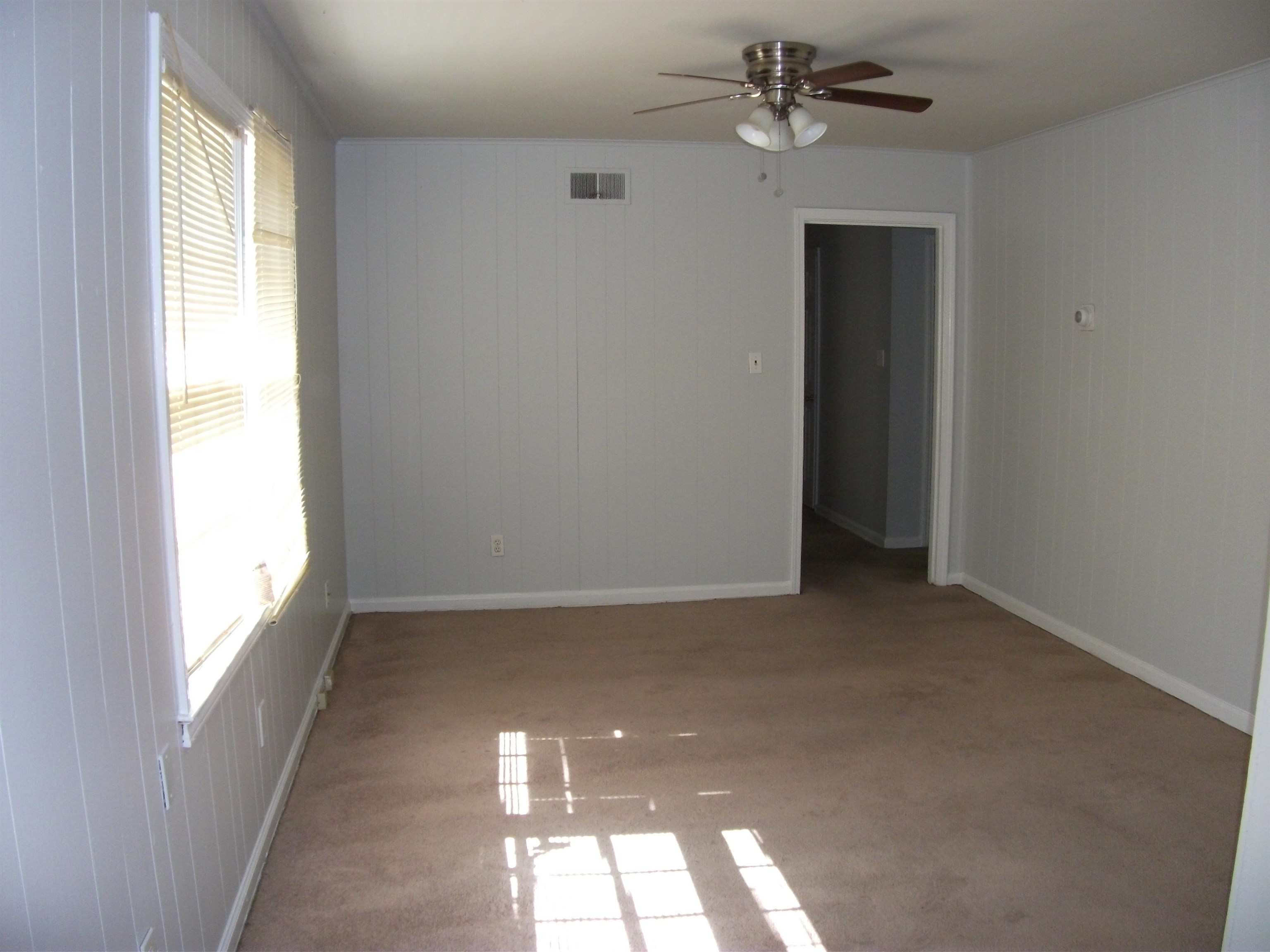409 Clower Road Memphis, TN 38109 - Photo 3 of 10 wooden floor in an empty room with a window