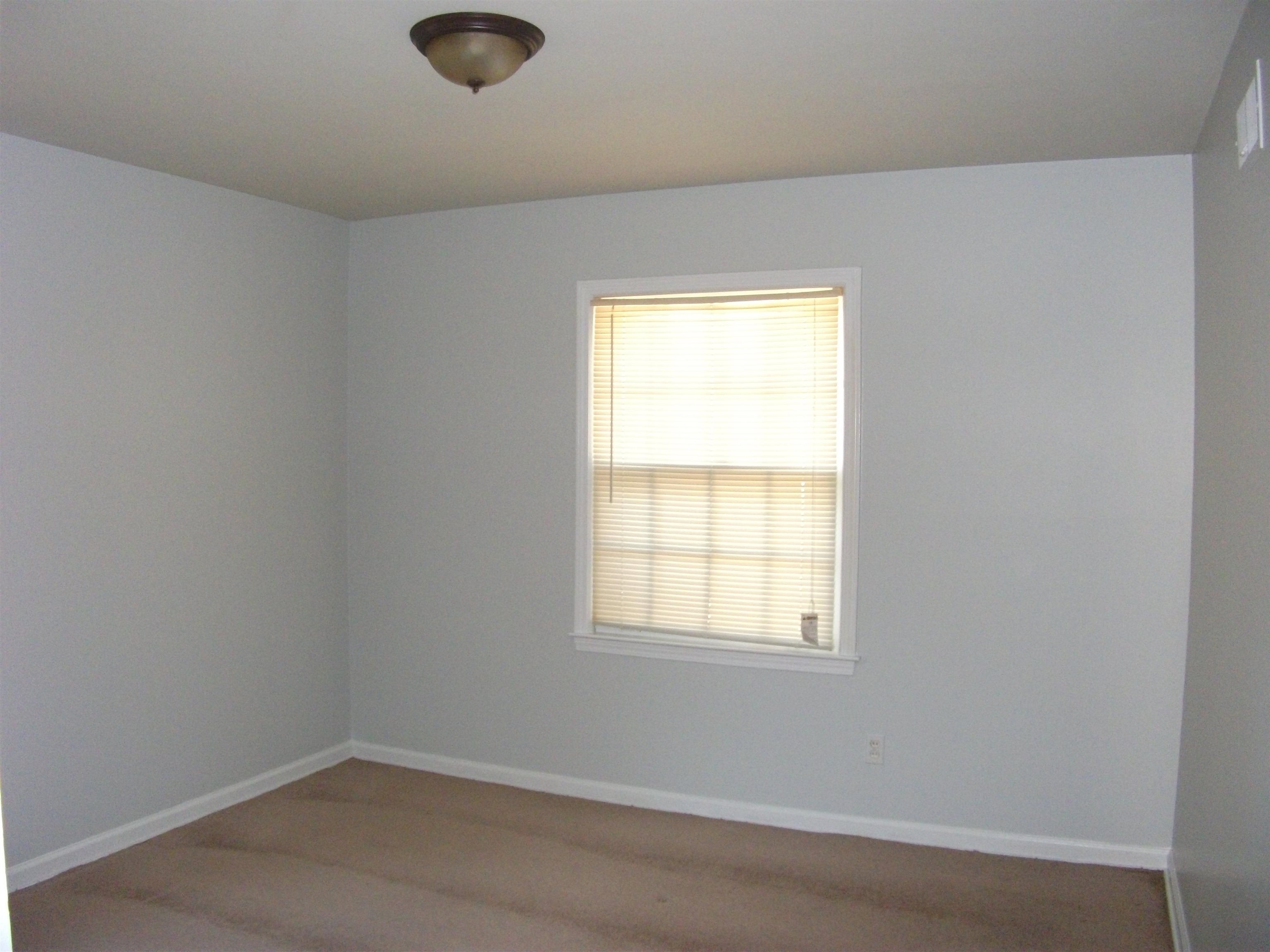 409 Clower Road Memphis, TN 38109 - Photo 9 of 10 an empty room with a window