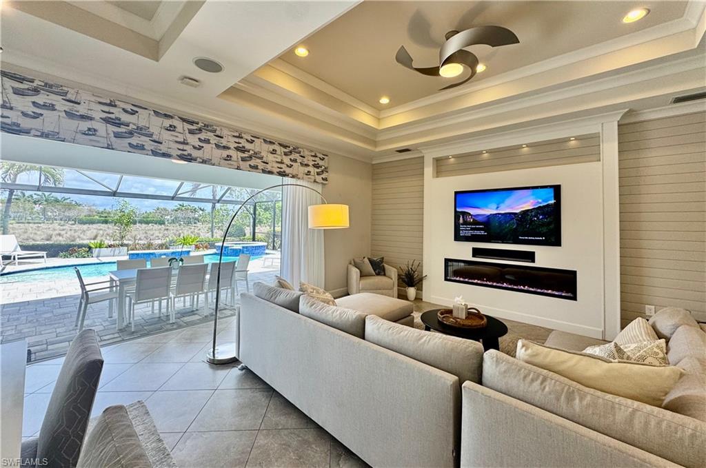 6466 Warwick Avenue Naples, FL 34113 - Photo 7 of 43 a living room with furniture and a flat screen tv