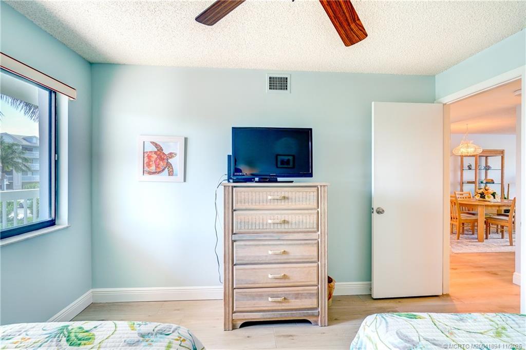 40 Northeast Plantation Road, Unit 209 Stuart, FL 34996 - Photo 12 of 36 a view of a bedroom with furniture and workspace