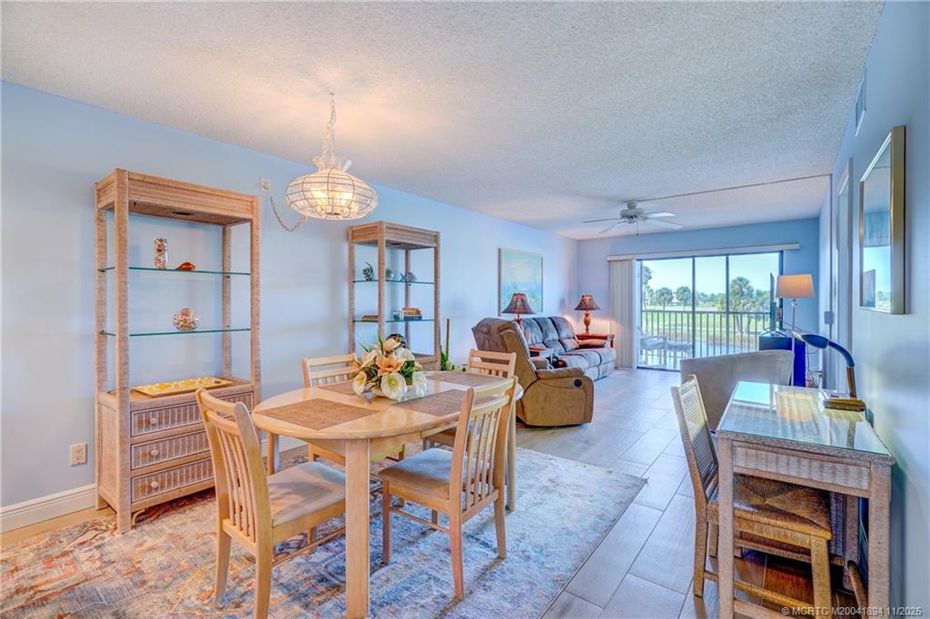 40 Northeast Plantation Road, Unit 209 Stuart, FL 34996 - Photo 15 of 36 a view of a dining room with furniture and chandelier