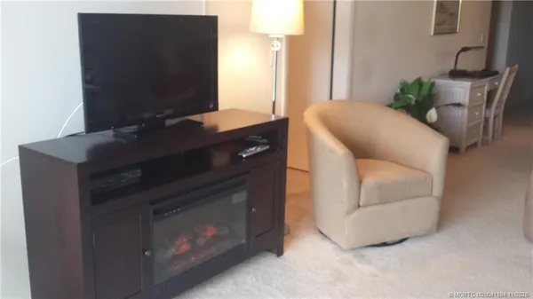 a living room with furniture and a lamp