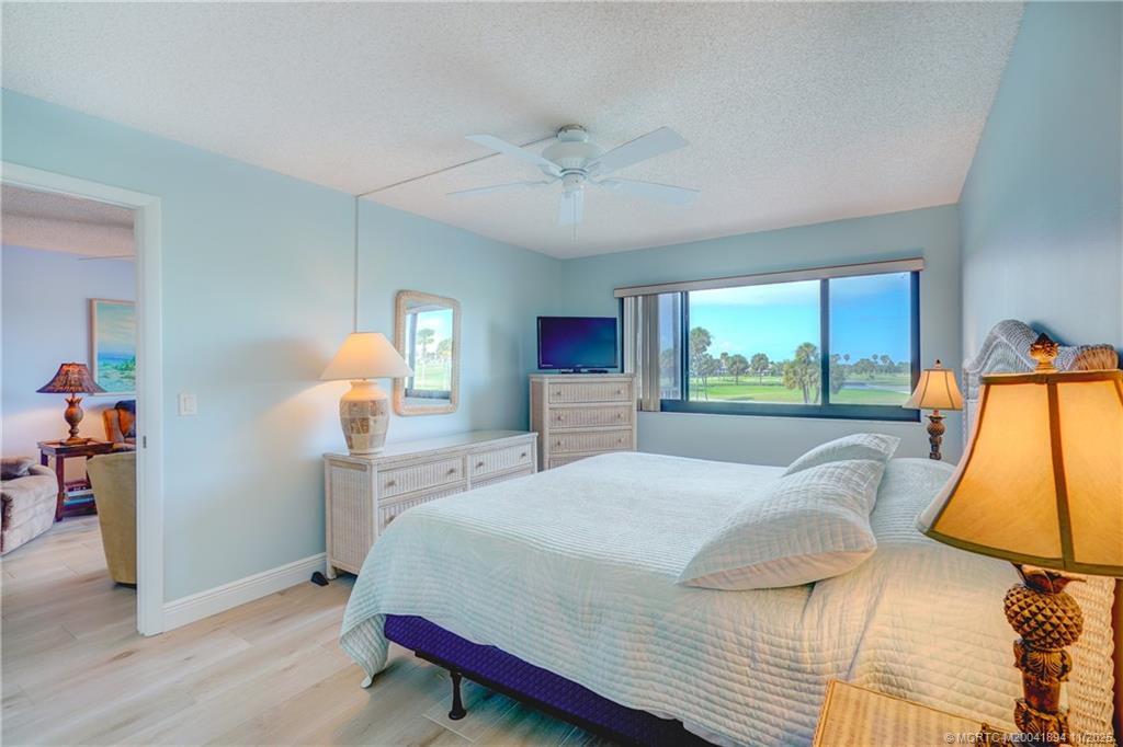 40 Northeast Plantation Road, Unit 209 Stuart, FL 34996 - Photo 20 of 36 a bedroom with a bed and a large window