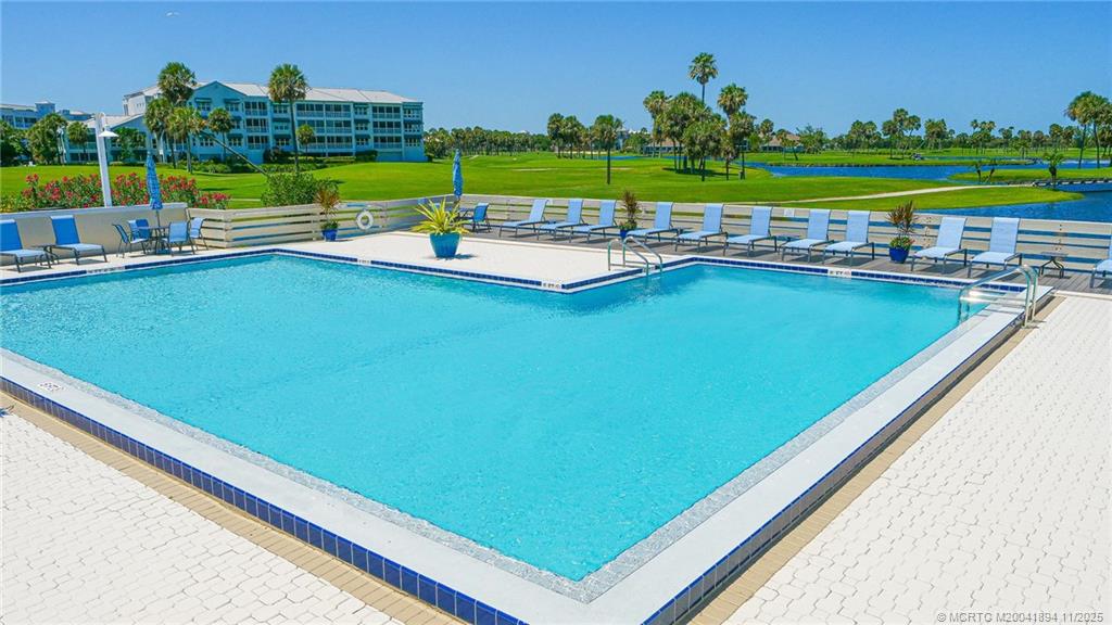 40 Northeast Plantation Road, Unit 209 Stuart, FL 34996 - Photo 26 of 36 a view of a pool with a yard and outdoor