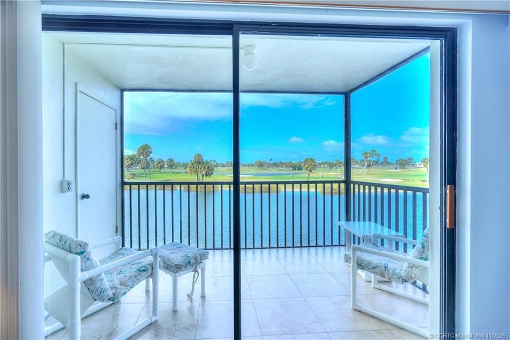 40 Northeast Plantation Road, Unit 209 Stuart, FL 34996 - Photo 34 of 36 a view of a porch with a floor to ceiling window