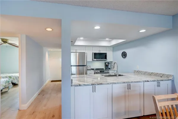 a living room with furniture a flat screen tv and a floor to ceiling window
