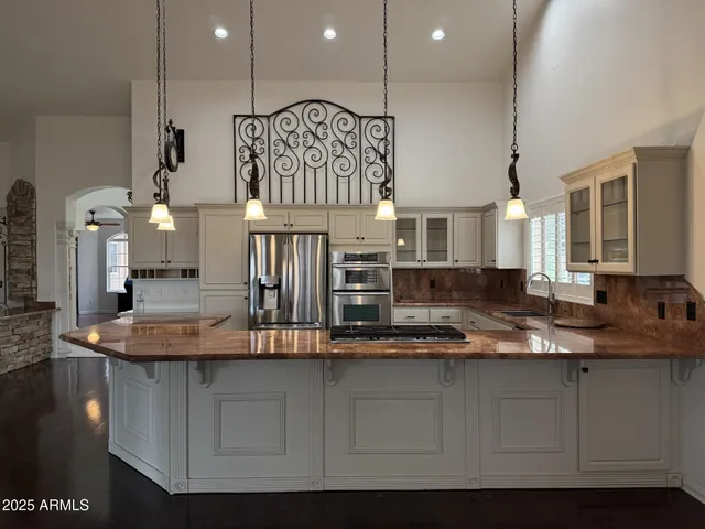 a view of kitchen with stainless steel appliances kitchen island