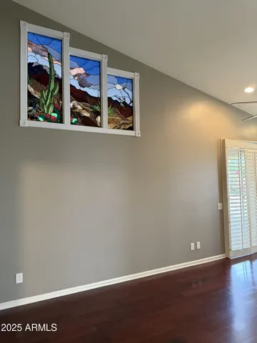 an empty room with painting on the wall