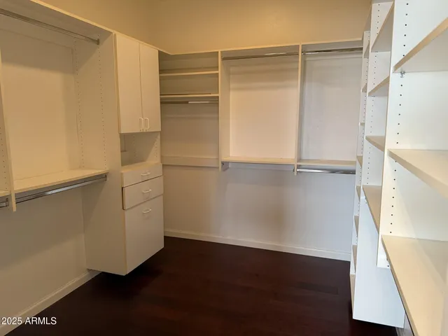 a view of walk in closet with empty racks