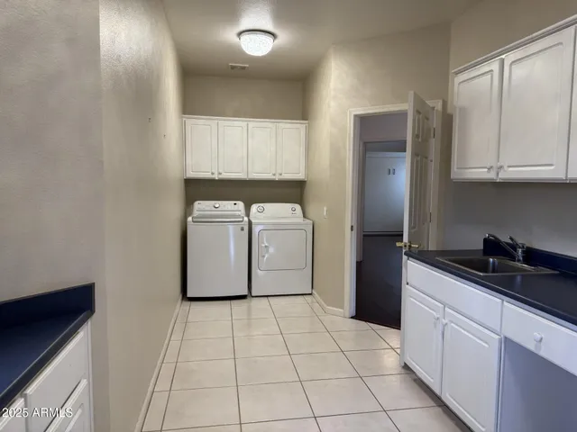 a kitchen with a sink a refrigerator and cabinets