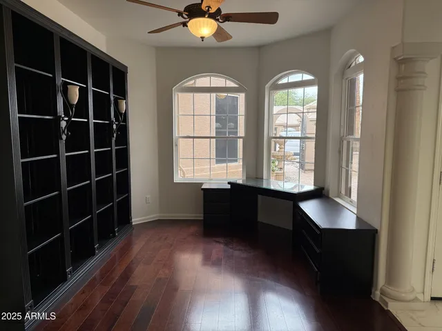 wooden floor with windows and chandelier