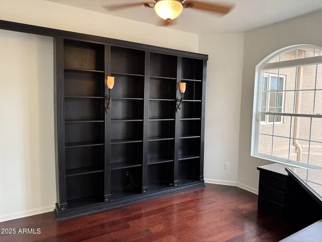 a view of a room with wooden floor and windows