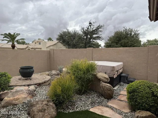 a backyard of a house with table and chairs