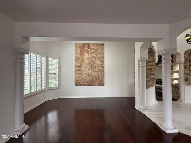 a view of wooden floor and windows in a room