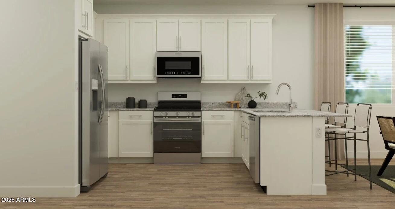 2168 Rutledge Avenue Apache Junction, AZ 85120 - Photo 2 of 16 a kitchen with a sink white cabinets and stainless steel appliances
