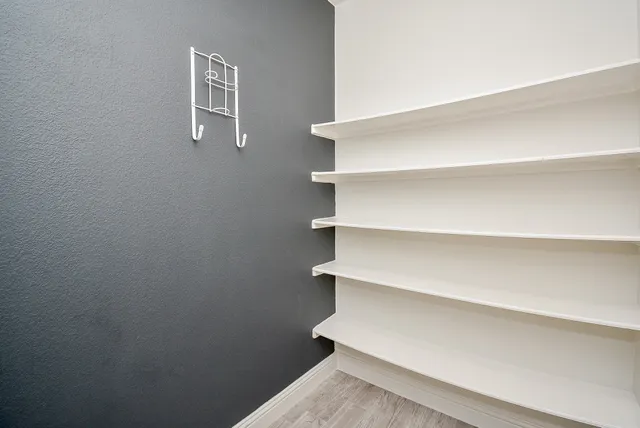 a view of walk in closet with empty racks