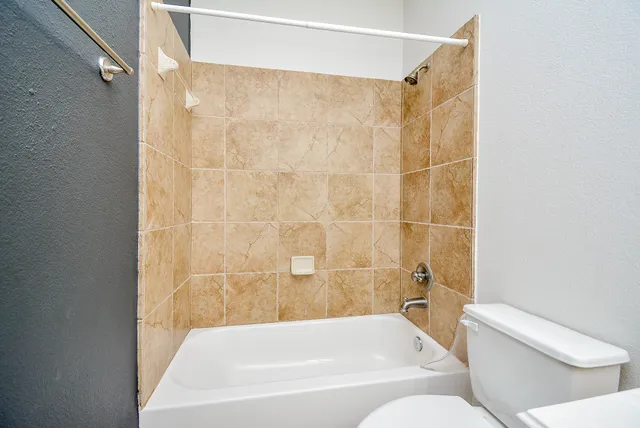 a bathroom with a bathtub and a toilet