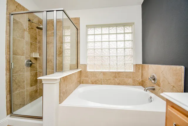a bathroom with a bathtub and shower