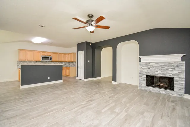 a view of a kitchen with a sink and a fireplace