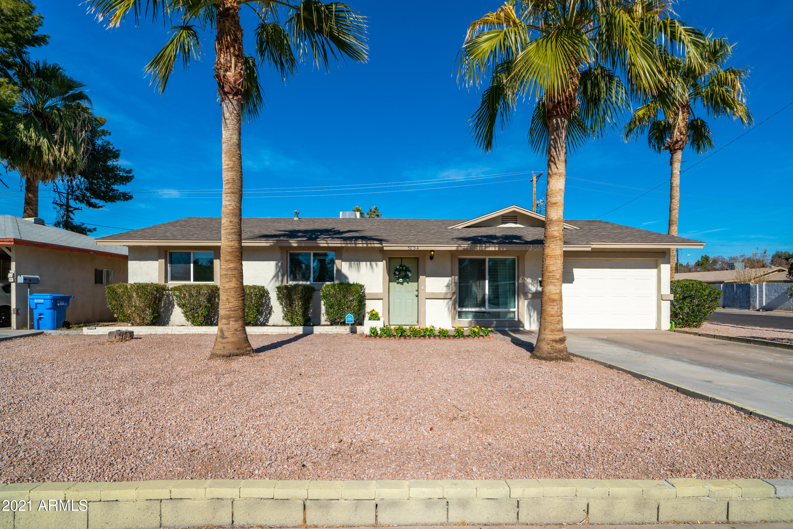 3034 East Osborn Road Phoenix, AZ 85016 - Photo 24 of 24 a front view of a house with garden and patio
