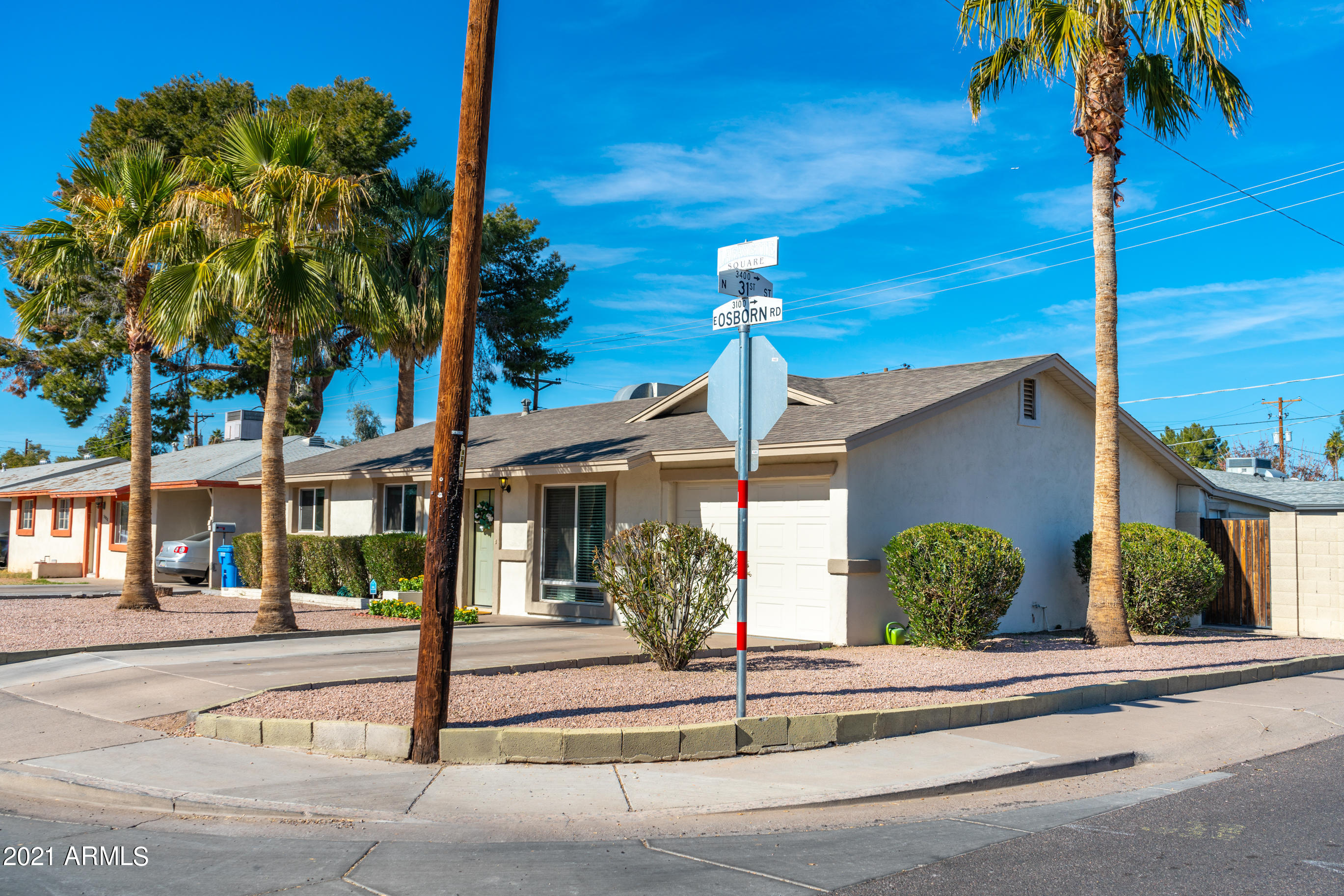 3034 East Osborn Road Phoenix, AZ 85016 - Photo 3 of 24 a front view of a building with palm trees