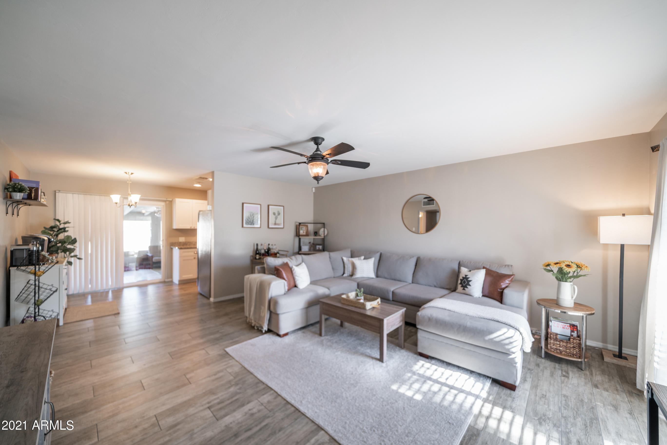 3034 East Osborn Road Phoenix, AZ 85016 - Photo 4 of 24 a living room with furniture a wooden floor and a chandelier