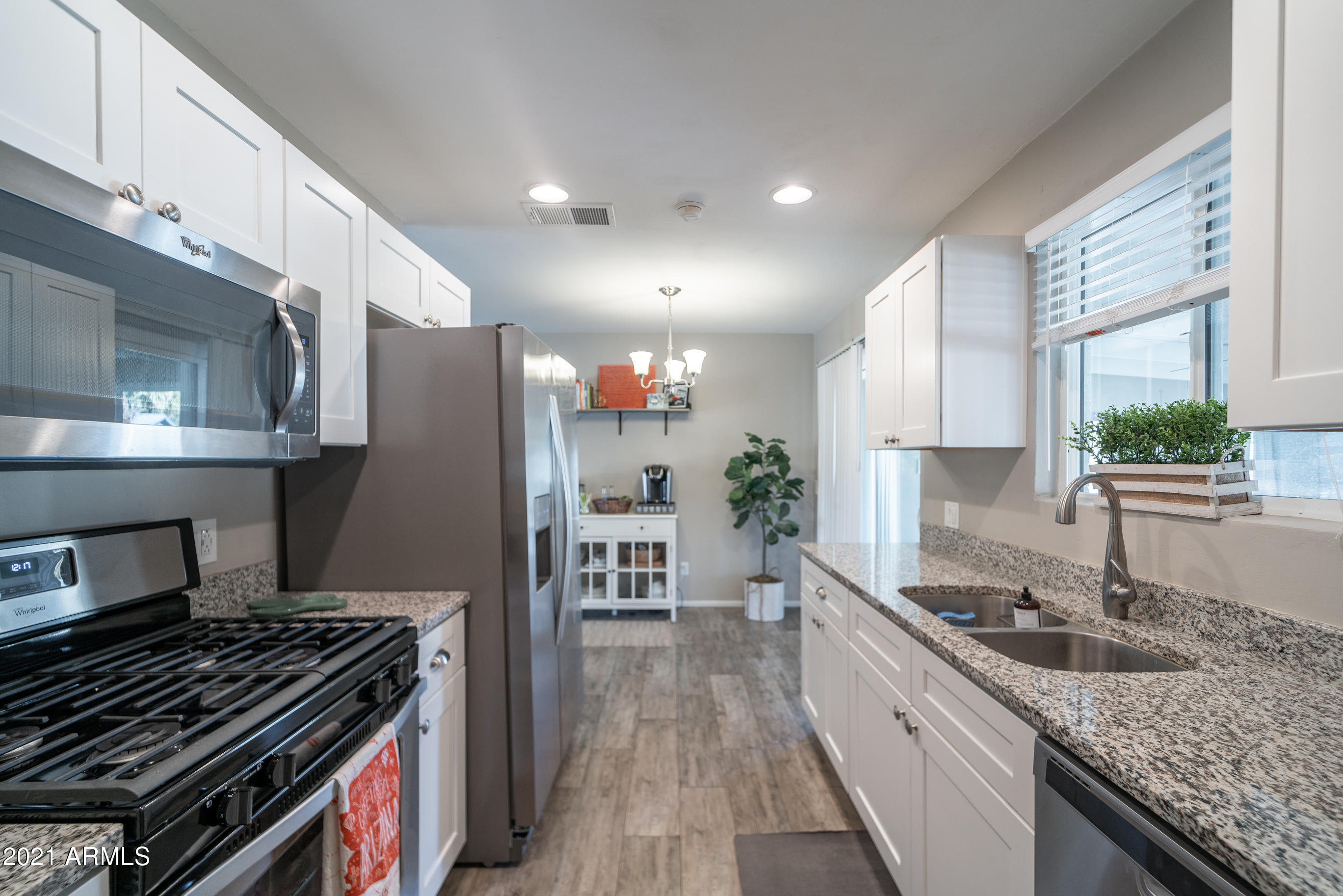 3034 East Osborn Road Phoenix, AZ 85016 - Photo 8 of 24 a kitchen with stainless steel appliances granite countertop a stove a sink and a refrigerator