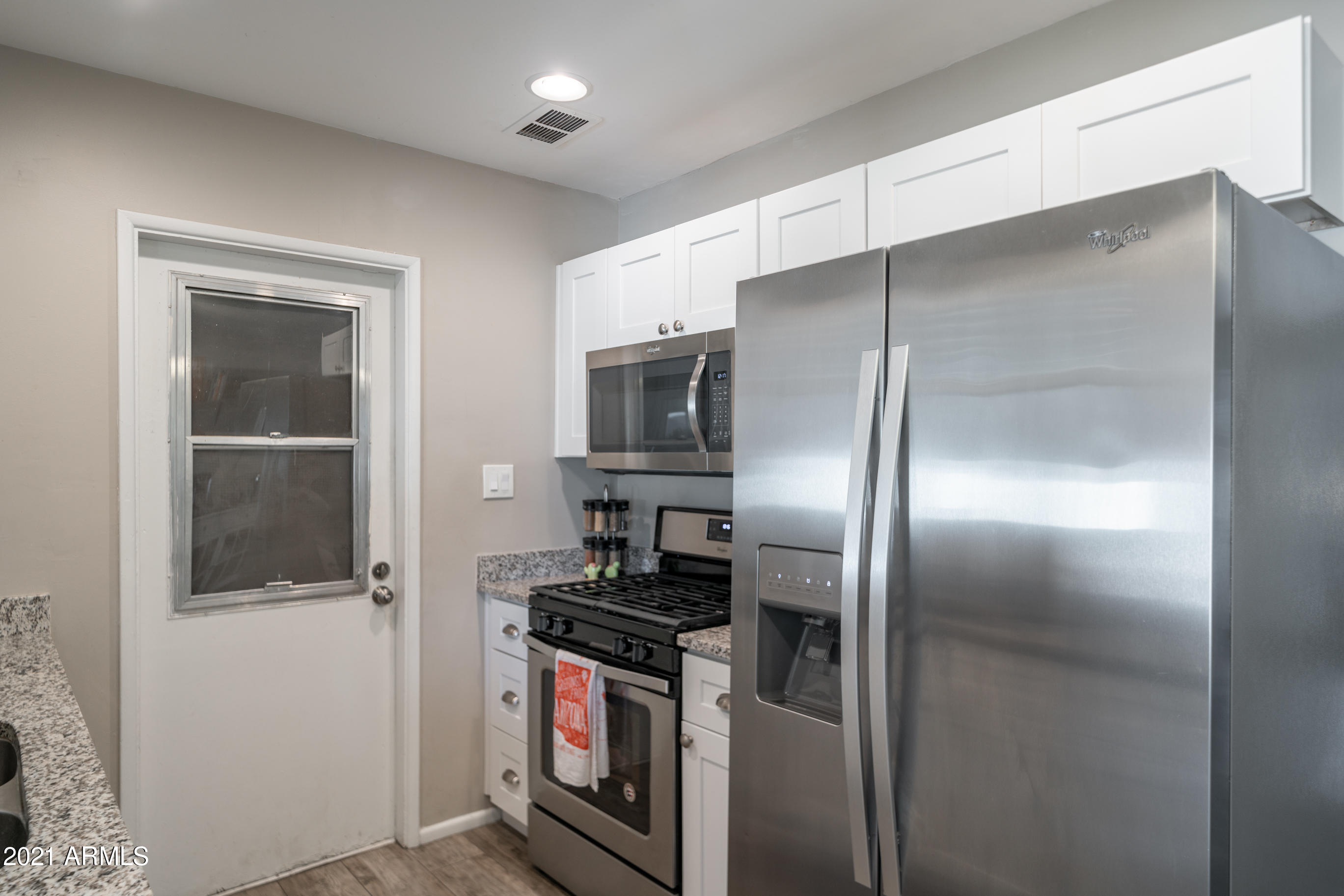 3034 East Osborn Road Phoenix, AZ 85016 - Photo 9 of 24 a kitchen with stainless steel appliances granite countertop a refrigerator and a stove