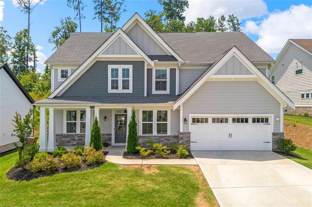 a view of house with yard and outdoor seating