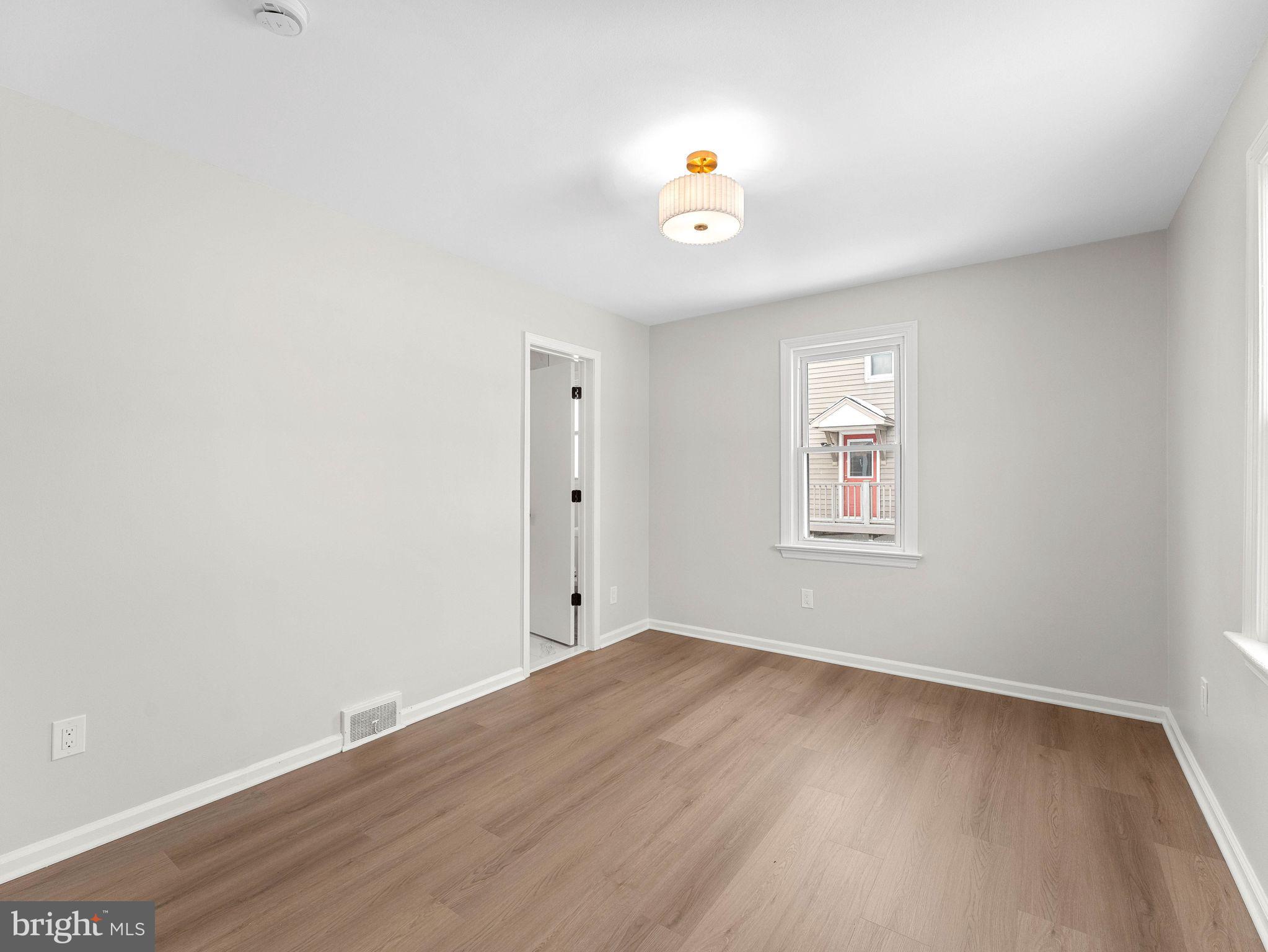 535 Main Street Glendora, NJ 08029 - Photo 13 of 33 an empty room with wooden floor and windows
