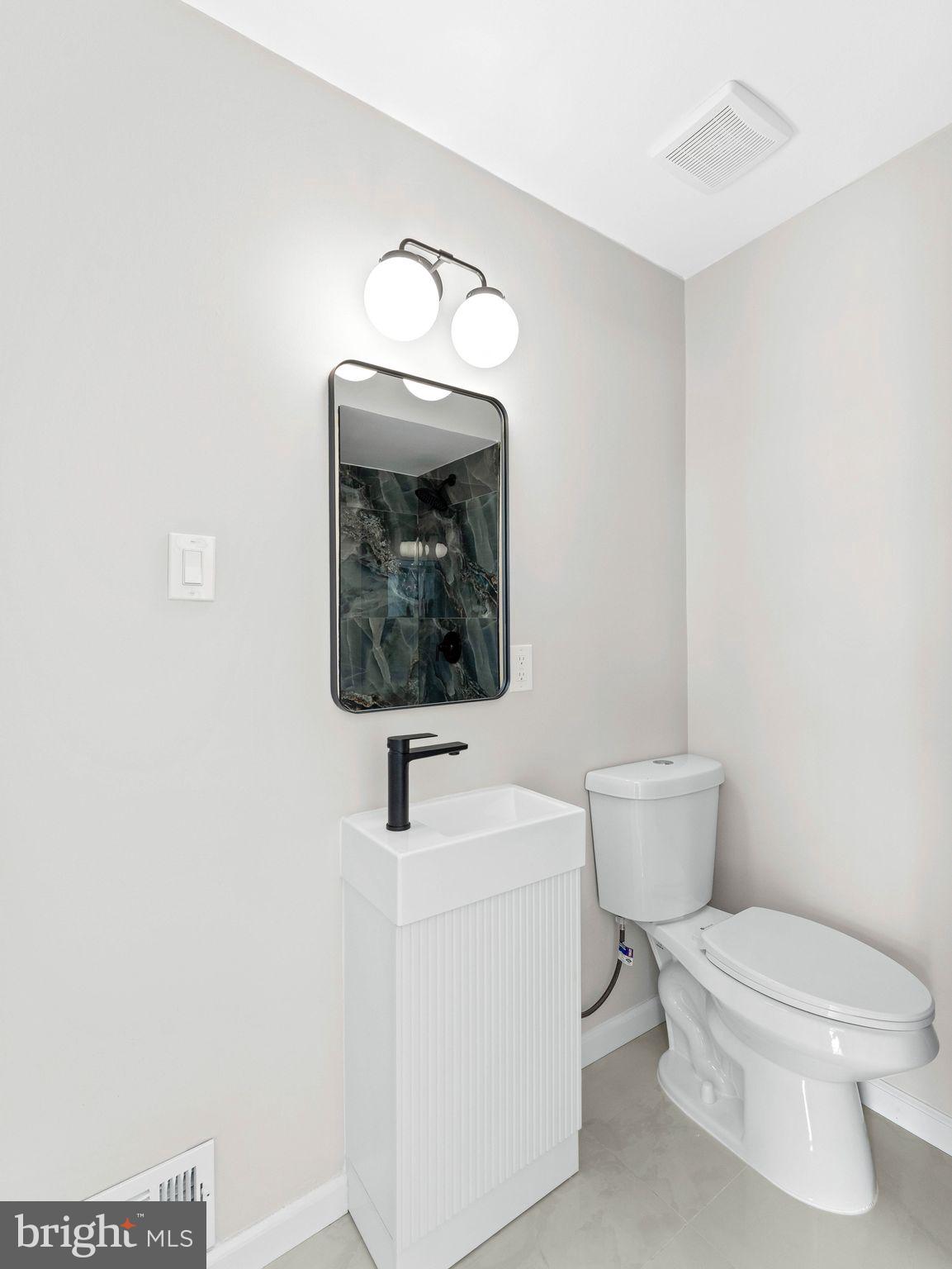 535 Main Street Glendora, NJ 08029 - Photo 20 of 33 a white toilet sitting next to a white sink