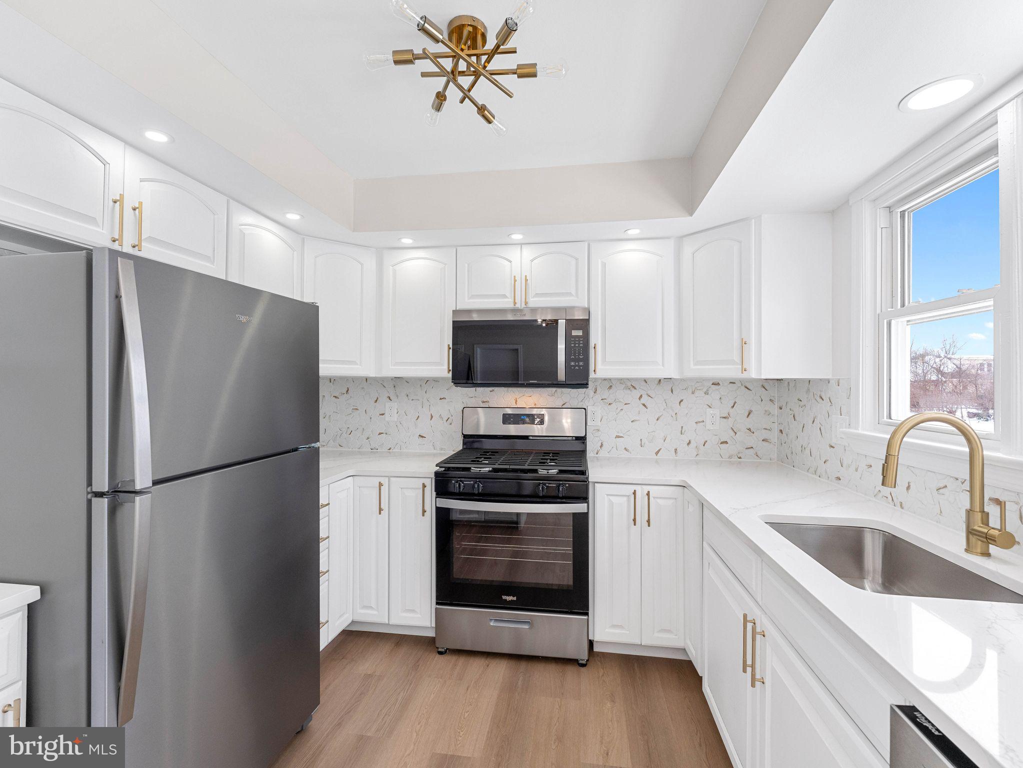 535 Main Street Glendora, NJ 08029 - Photo 9 of 33 a kitchen with a refrigerator stove and sink