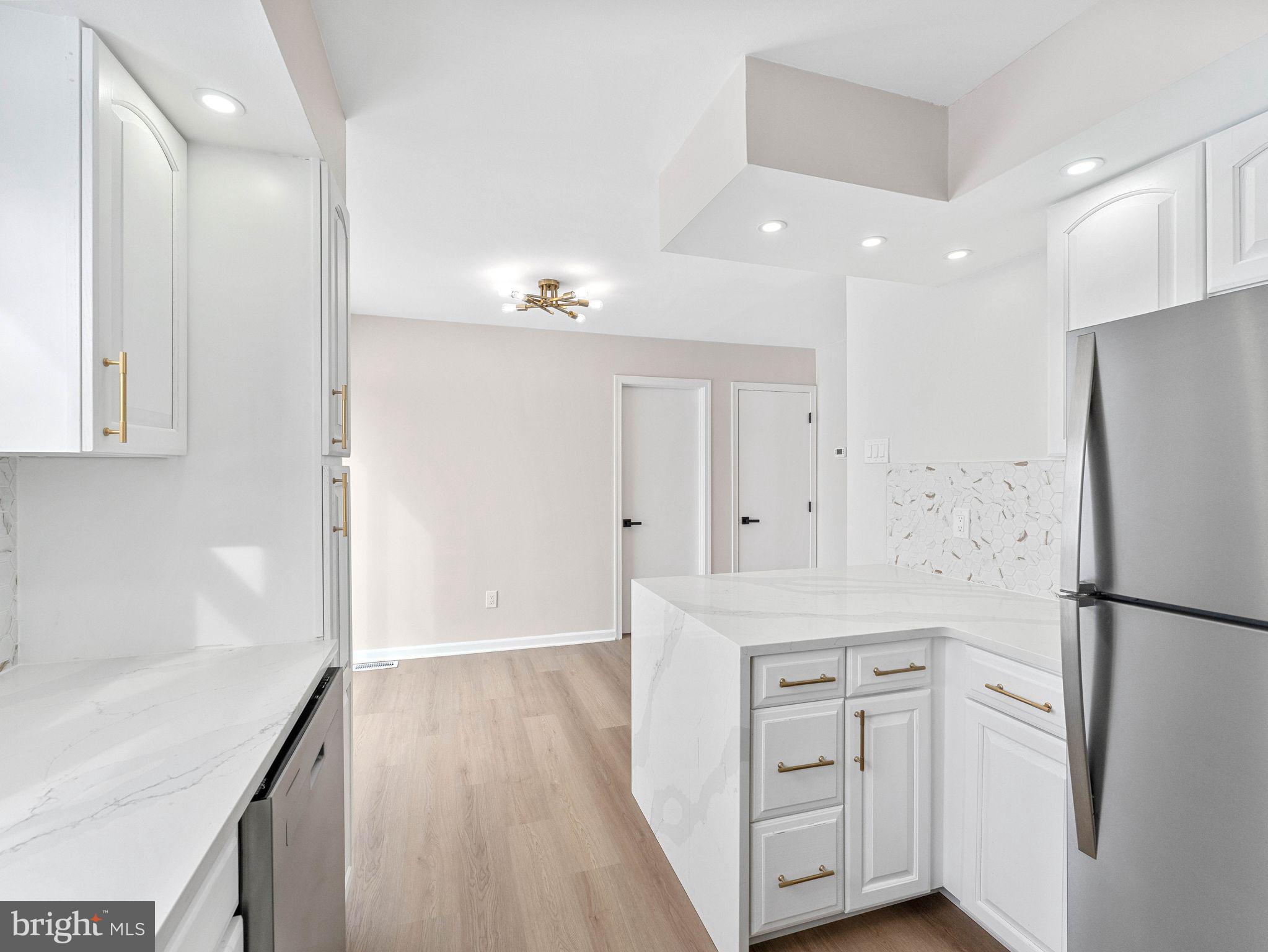 535 Main Street Glendora, NJ 08029 - Photo 10 of 33 a kitchen with white cabinets and refrigerator